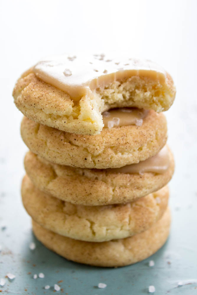stack of snickerdoodle cookies with caramel and sea salt, bite out of the top cookie