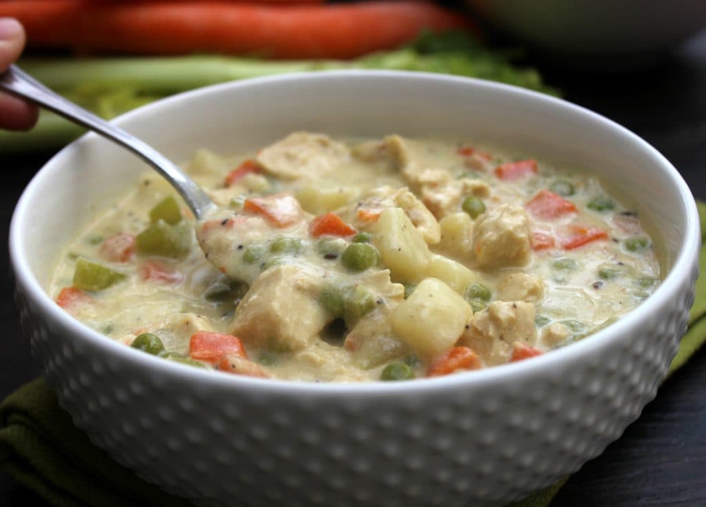 CHICKEN POT PIE SOUP - a deliciously simple soup recipe made from scratch. A fantastic classic comfort food brought to you in bowl. spoonful of chicken pot pie soup in a white bowl