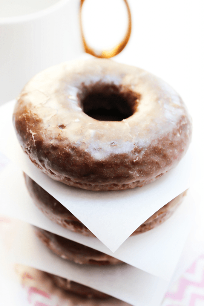 COPYCAT STARBUCKS DEVIL'S FOOD DONUTS are insanely delicious. Covered in a vanilla-butter glaze, they're better that the real deal and healthier too! DEVIL'S FOOD DONUTS devils food donut, chocolate, vanilla glaze, starbucks cup, white coffee mug, gold handled mug, donut stack, baked donut, devil's food cake