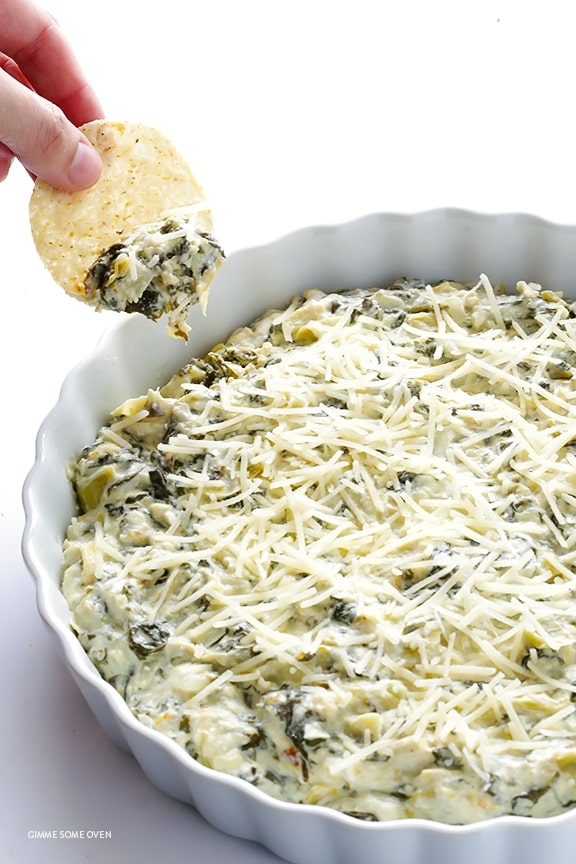 slow cooker spinach artichoke dip appetizer with chips and parmesan cheese