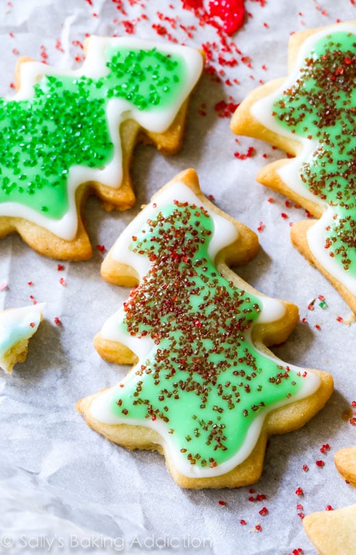 Christmas tree sugar cookie with green and white frosting and red sprinkles