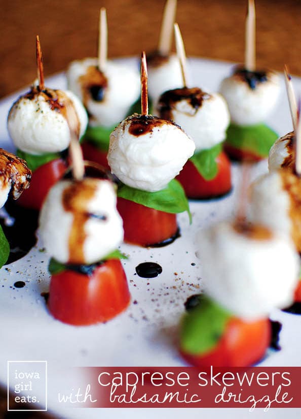 Caprese Skewers with Balsamic Drizzle mozzarella balls, cherry tomatoes, spinach leaves, and balsamic vinegar