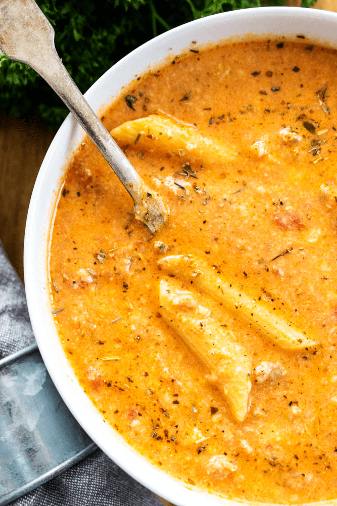 CREAMY ITALIAN SAUSAGE SOUP - A cheesy, pasta-filled soup made with Italian sausage. It’s the perfect pairing for an easy weeknight dinner or holiday party. CREAMY ITALIAN SAUSAGE SOUP spoon and pasta detail