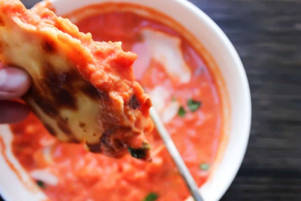 20-MINUTE CREAMY TOMATO BASIL SOUP is a classic comfort food and the is best tomato soup, thanks to 2 secret ingredients. grilled cheese dipped in tomato soup