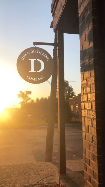 picture of iowa distilling sign at sunset
