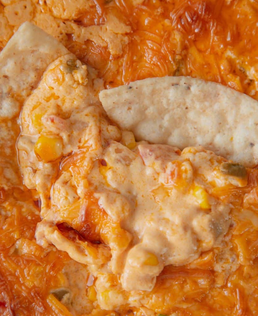 Grab a bag of chips and dig in. This Corn Queso dip is insanely cheesy, creamy & delicious. It will become your new favorite game day cheese dip. cheesy corn dip with chips