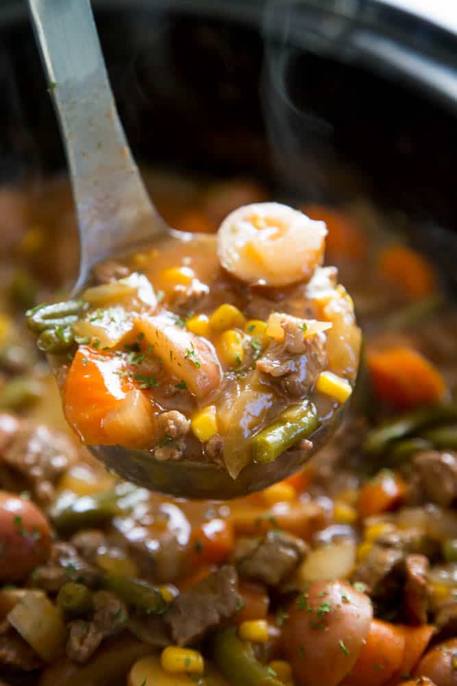 Beef Stew a comfort food that is best slow-cooked. Packed with meat, potatoes, and veggies, this recipe is great to have on hand for busy nights. beef stew in slow cooker with ladle